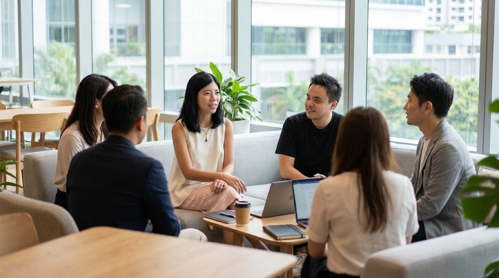 Novastacks operators in a casual office lounge, discussing a client's AI search strategy
